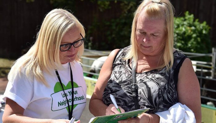 A Salix Homes staff member speaking to a customer