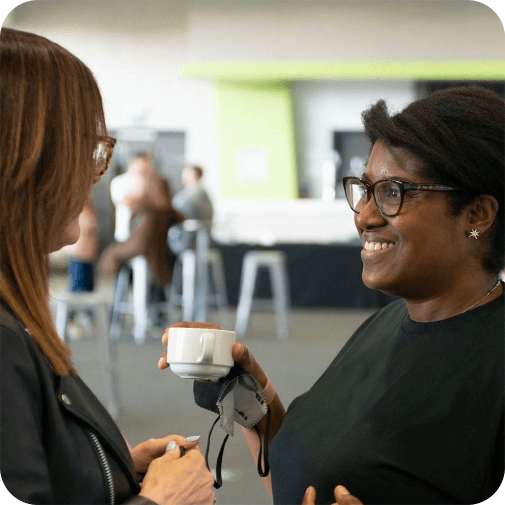 Two women chatting over a cup of coffee